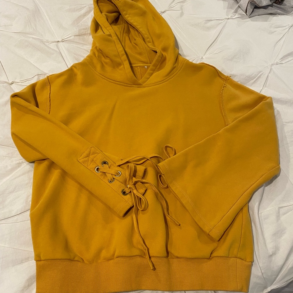 Yellow/gold soft styling hoodie with tie flare sleeves.